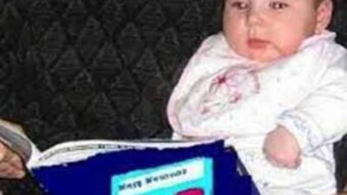 Math mutation image, showing an infant reading a blue book