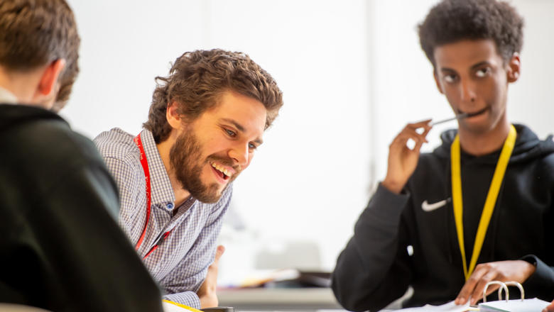 A teacher working with two students